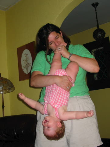 Bethany nibbling on the feet of a happy, upside down Jane